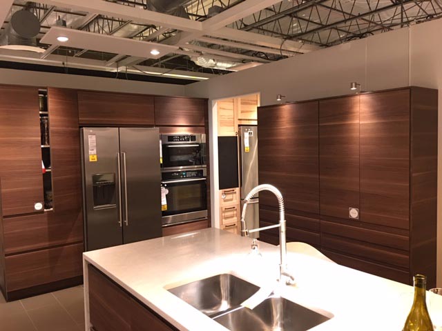 Example of a kitchen set up with wooden cabinets in an IKEA warehouse