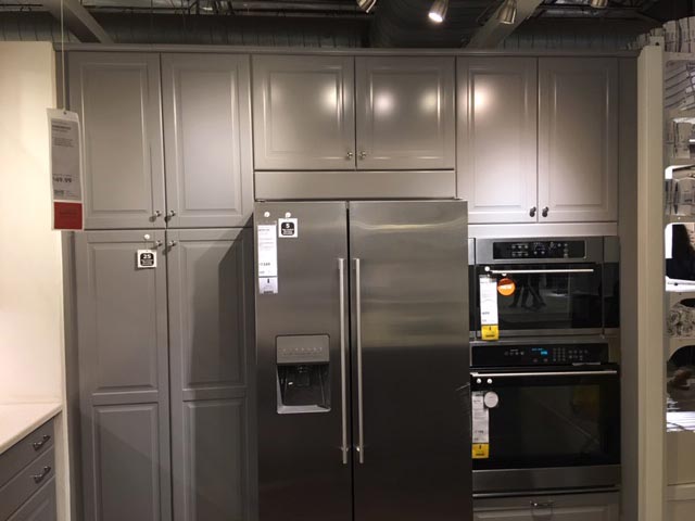 Sample kitchen set up with gray cabinets in IKEA warehouse