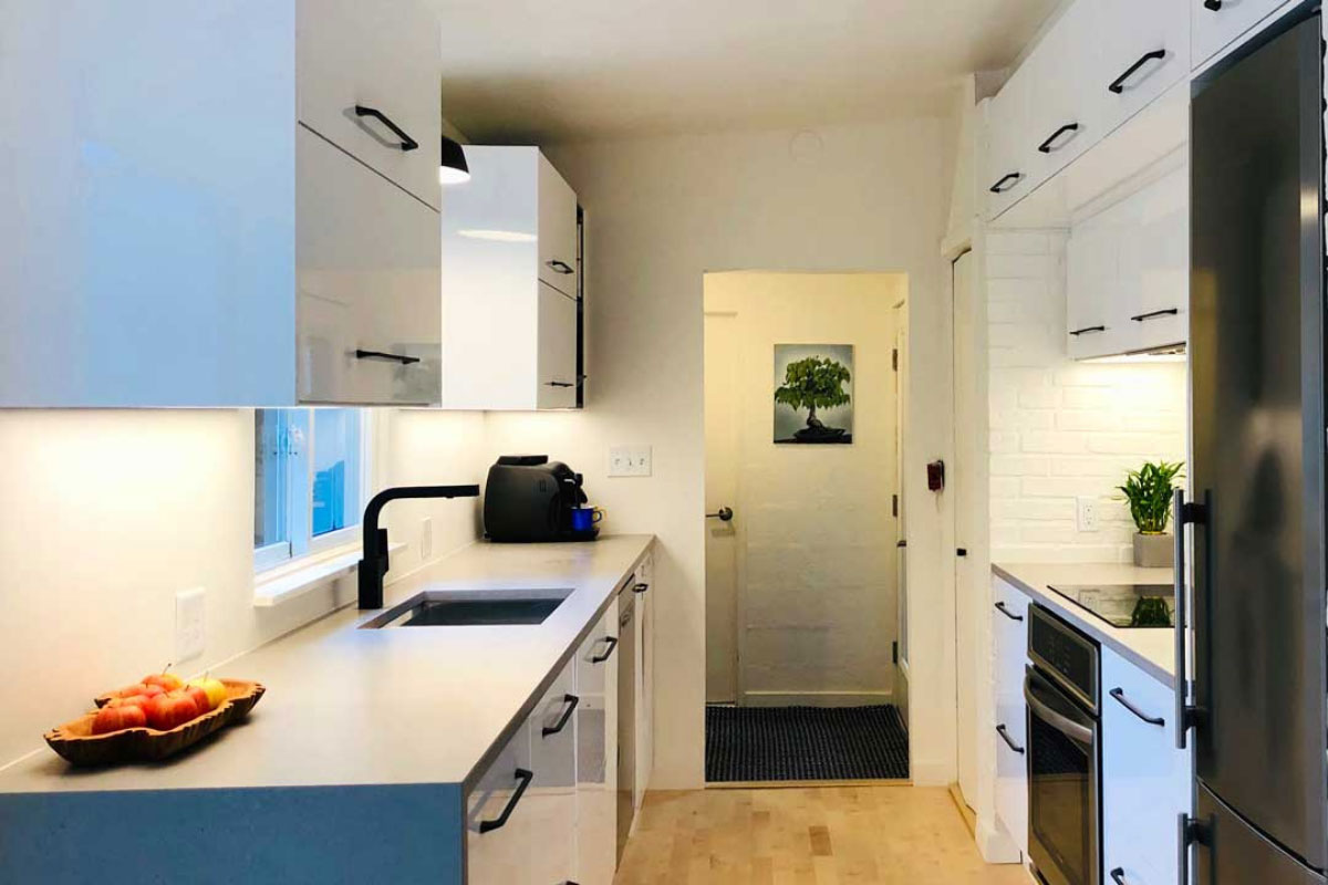 Efficient galley kitchen layout with parallel counters highlighting fixtures and appliances.