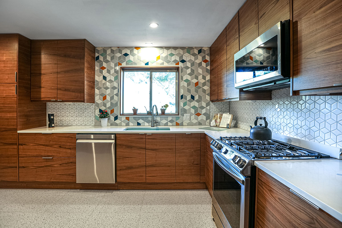 Modern style kitchen with light counter top with sink, hob, oven