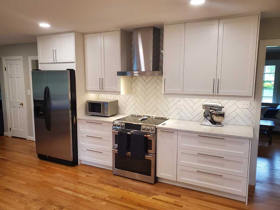 white kitchen cabinets with stainless steel appliances