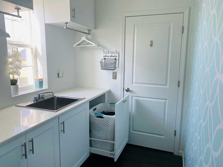 Pull-out drawer for hamper in laundry room