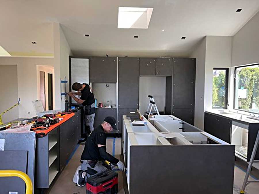 Kitchen install team working on cabinets