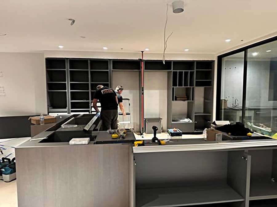 Cabinets being installed in new kitchen