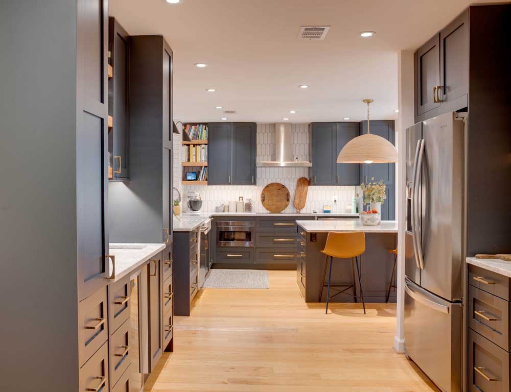 Dark blue cabinets with white countertops in kitchen