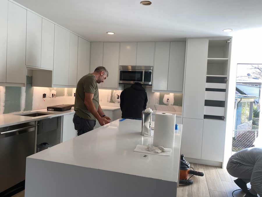 Kitchen remodel team working on cabinets