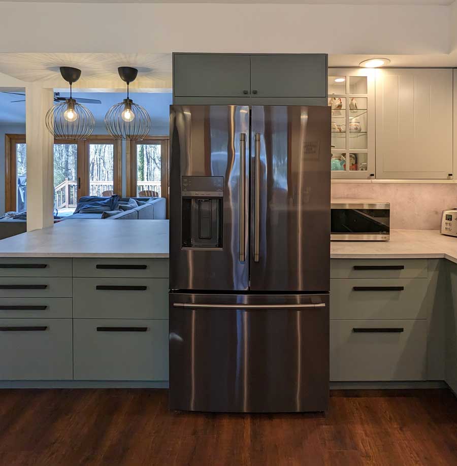 Stainless steel refrigerator in the middle of the kitchen island