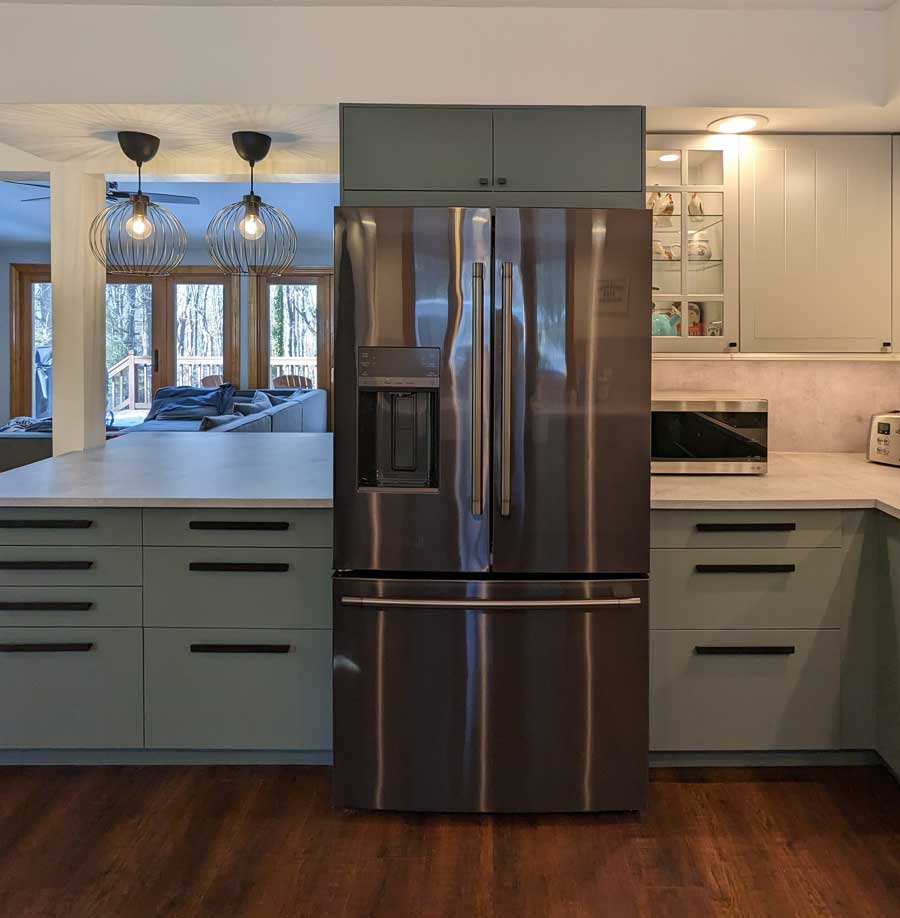 stainless steel fridge in middle of kitchen island