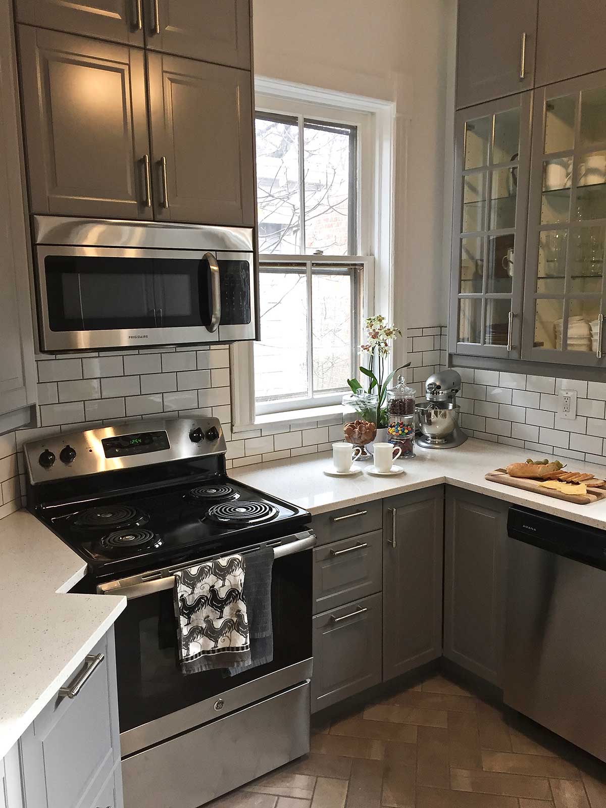 White/grey kitchen with black appliances