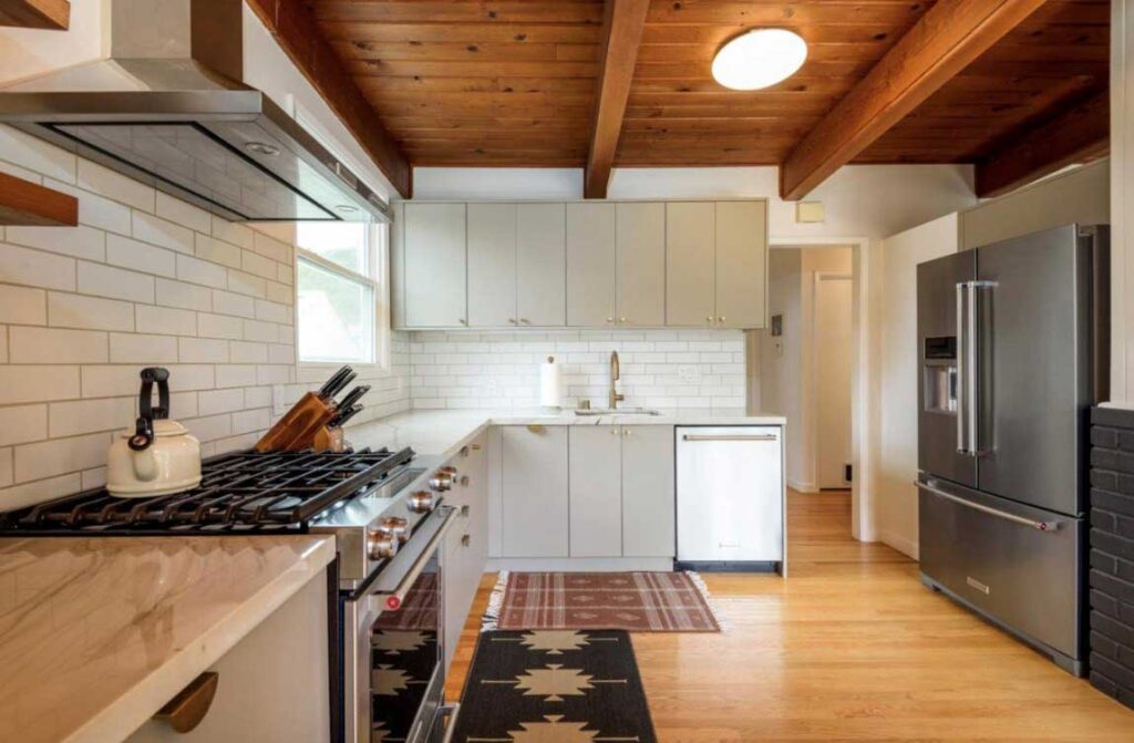 L-Shaped IKEA kitchen with brick tile backsplash