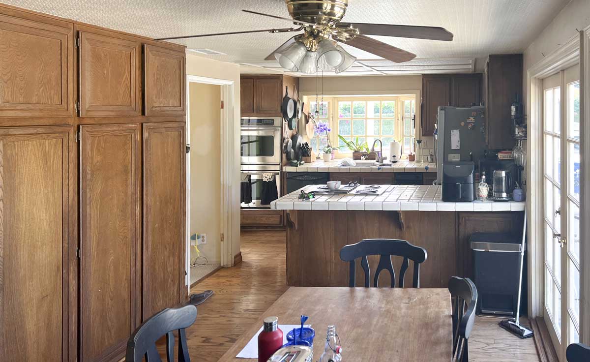 dark and drab original kitchen that's small and unorganized