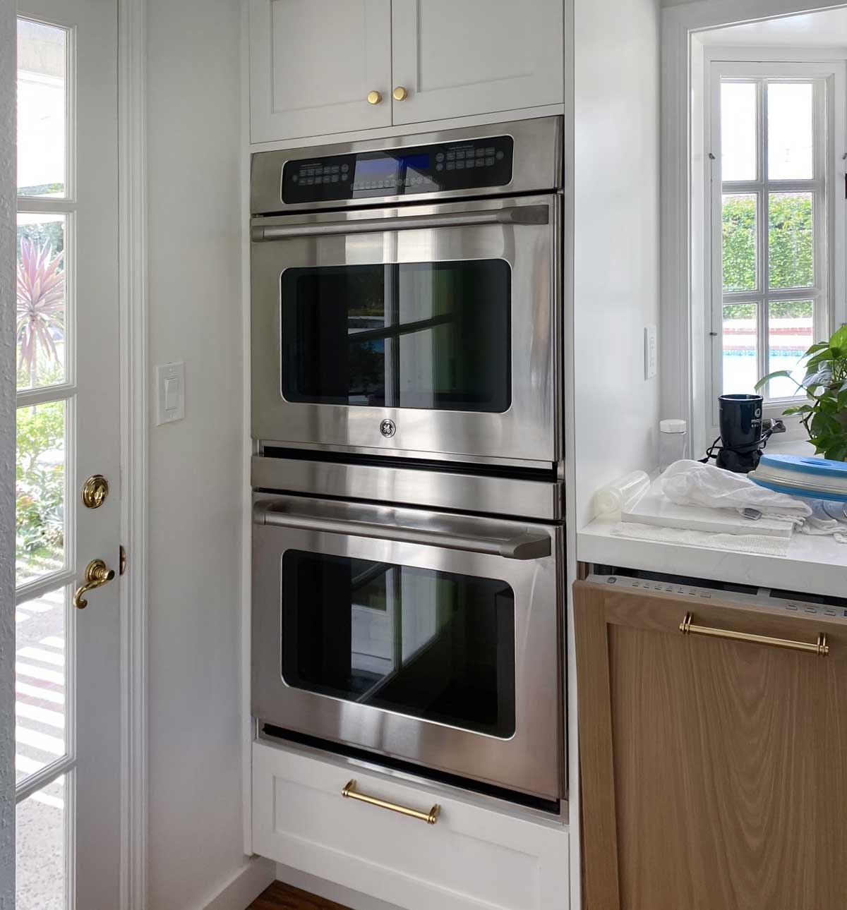 GE double oven with custom configured cabinets and two Scherr’s doors