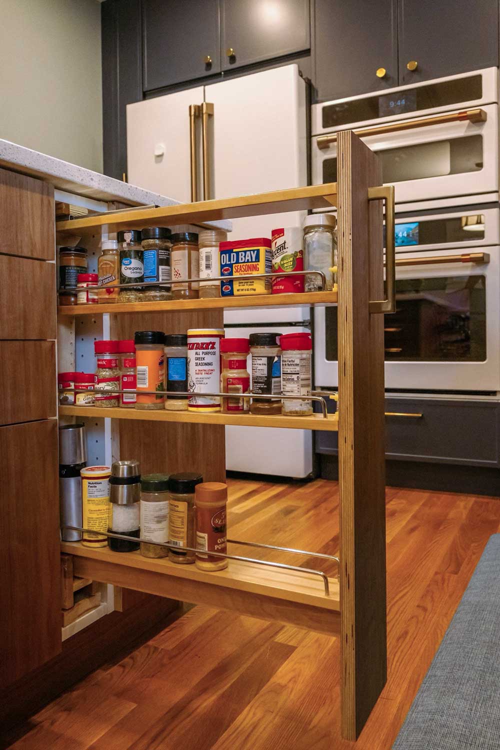 Pull-out spice storage in a kitchen island cabinet